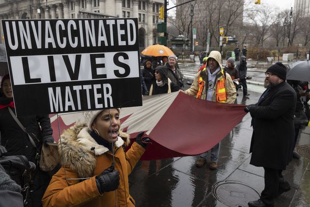 A person holds a sign during the anti-vaccine mandate protest ahead of possible termination of New York City employees due to their vaccination status, February 7th, 2022